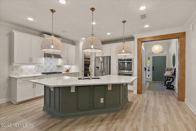 kitchen featuring sink, stainless steel appliances, and white cabinets