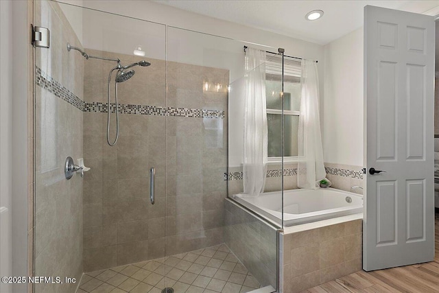 bathroom featuring plus walk in shower and wood-type flooring