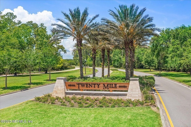 community / neighborhood sign with a yard