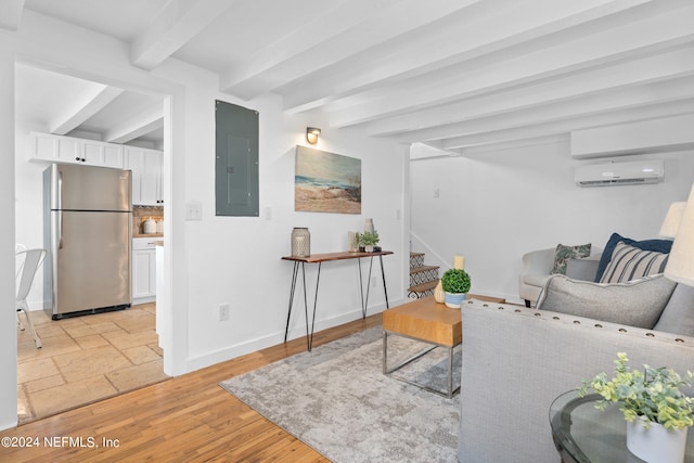 living room featuring beam ceiling, light hardwood / wood-style flooring, an AC wall unit, and electric panel