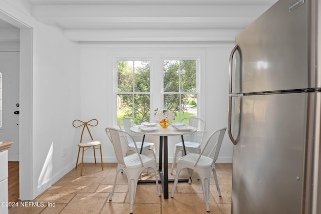 dining area with beamed ceiling