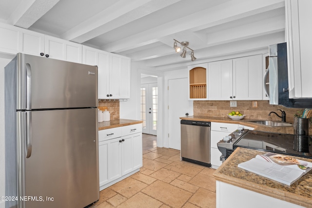 kitchen featuring sink, white cabinets, tasteful backsplash, and stainless steel appliances