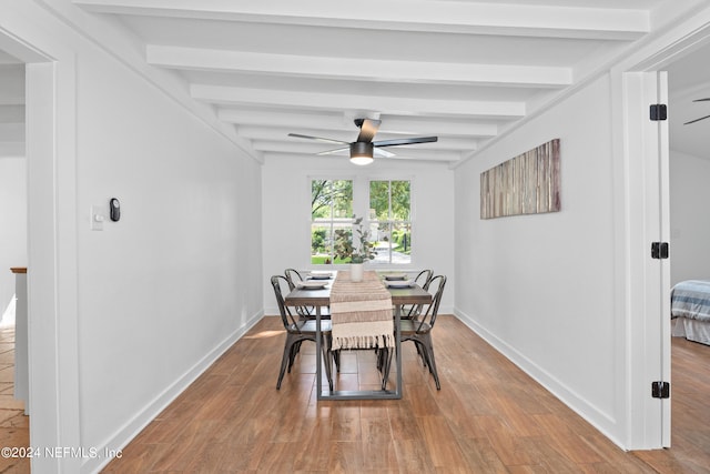 dining space featuring ceiling fan, beamed ceiling, and wood-type flooring