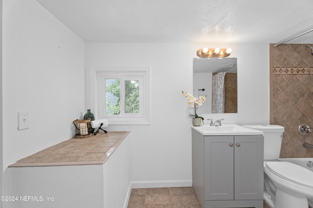 bathroom featuring vanity, toilet, and tile patterned flooring