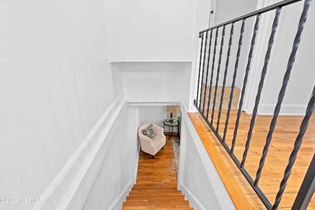 stairway featuring wood-type flooring