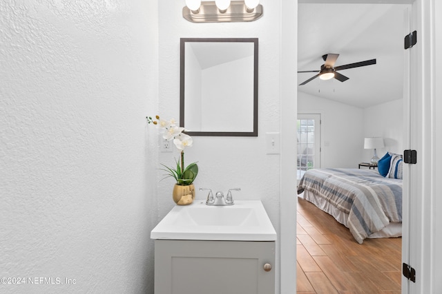 bathroom with vanity, vaulted ceiling, and ceiling fan