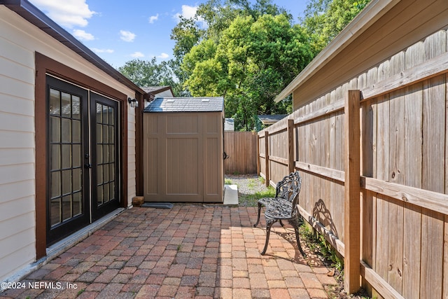 view of patio / terrace with french doors and a shed