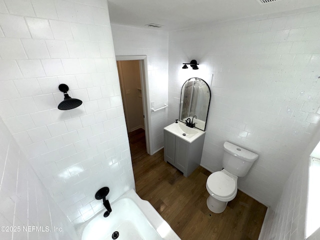 bathroom with hardwood / wood-style floors, toilet, and vanity