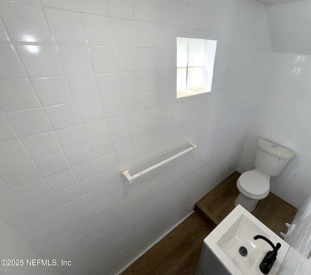 bathroom featuring hardwood / wood-style flooring, sink, and toilet