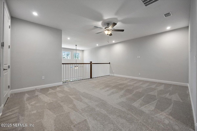 carpeted spare room with ceiling fan