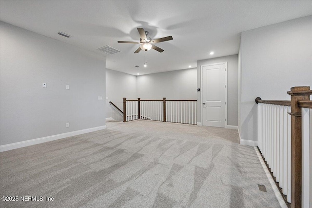 carpeted spare room with ceiling fan