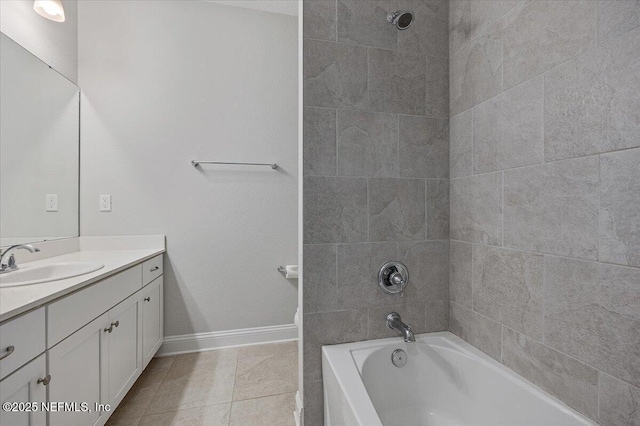 bathroom featuring tiled shower / bath, vanity, and tile patterned floors