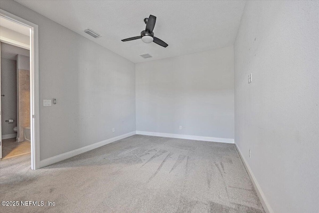 unfurnished room with ceiling fan, a textured ceiling, and carpet