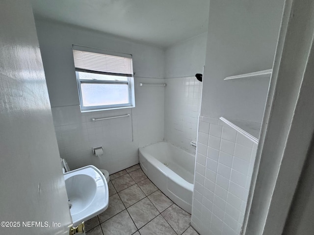 bathroom with sink, tile walls, shower / washtub combination, and tile patterned flooring