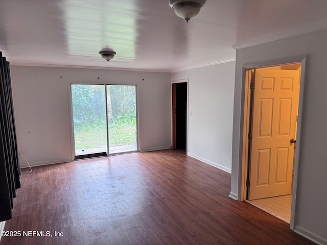 empty room with hardwood / wood-style floors and crown molding