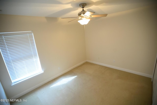 empty room with light colored carpet and ceiling fan