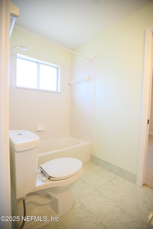 bathroom featuring toilet and shower / bathing tub combination