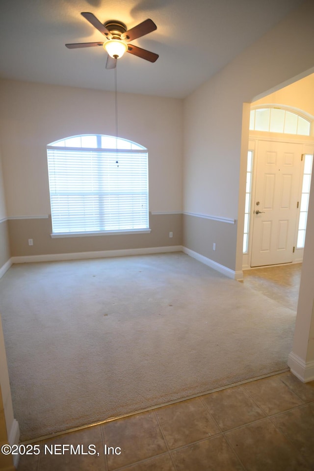 interior space with ceiling fan