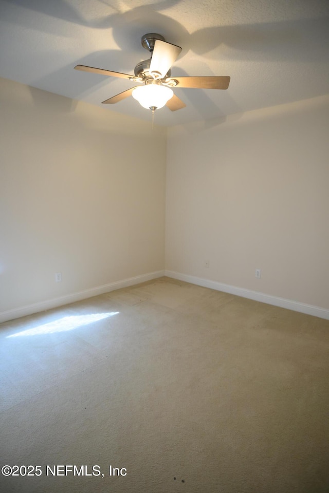 empty room with carpet flooring and ceiling fan