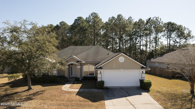 single story home with a garage and a front lawn