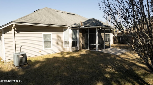 back of house with a patio, a sunroom, cooling unit, and a lawn