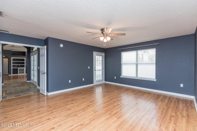 unfurnished room featuring a textured ceiling, wood-type flooring, and ceiling fan