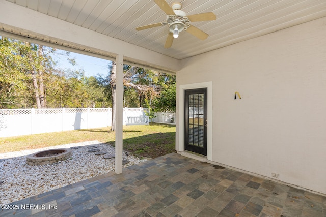 view of patio / terrace with a fire pit and ceiling fan