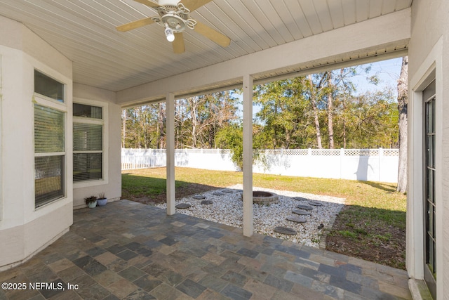 unfurnished sunroom with wooden ceiling and ceiling fan