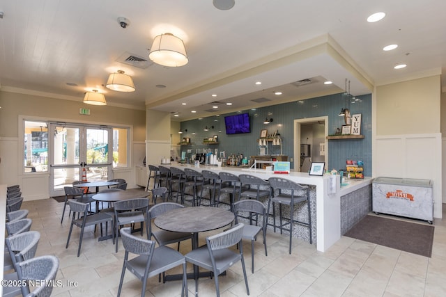 dining space featuring ornamental molding, light tile patterned floors, and french doors