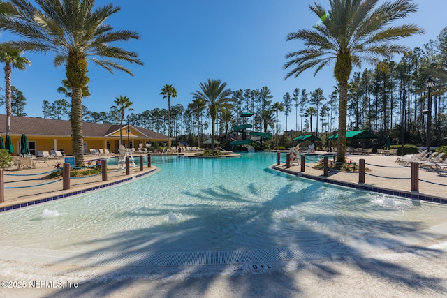 view of swimming pool with a patio area and pool water feature