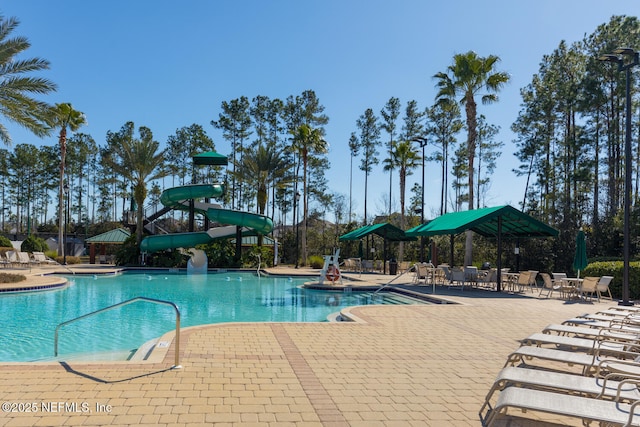 view of swimming pool featuring a patio and a water slide