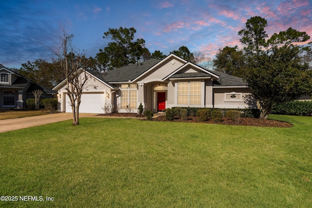 view of front of property with a garage and a yard