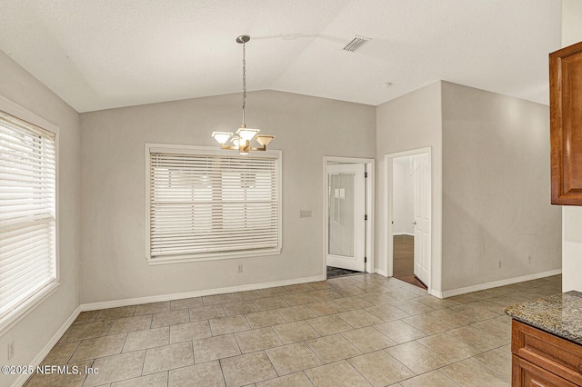 unfurnished dining area featuring vaulted ceiling, light tile patterned floors, and a chandelier