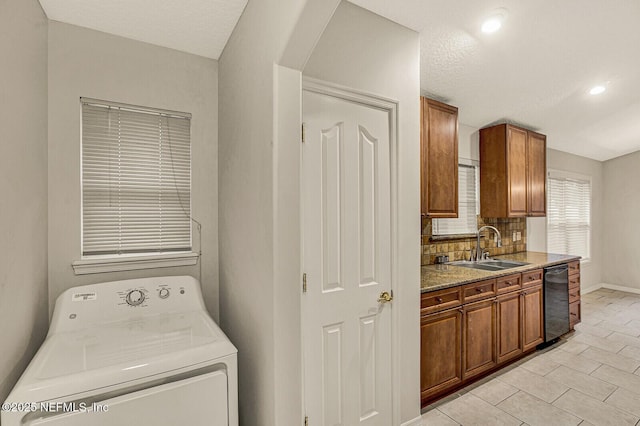 laundry room featuring light tile patterned flooring, washer / dryer, and sink