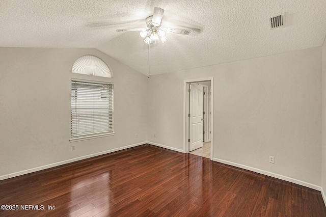 unfurnished room featuring hardwood / wood-style flooring, ceiling fan, vaulted ceiling, and a textured ceiling