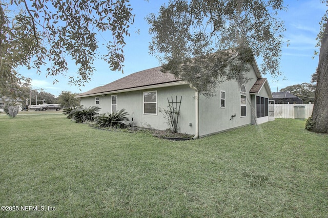 view of side of home featuring a yard