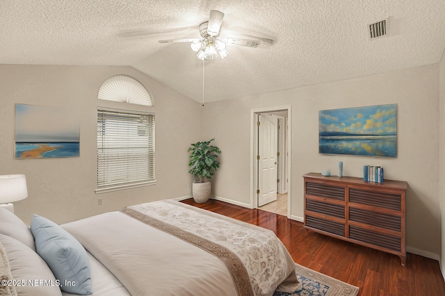 bedroom featuring hardwood / wood-style floors, a textured ceiling, vaulted ceiling, and ceiling fan