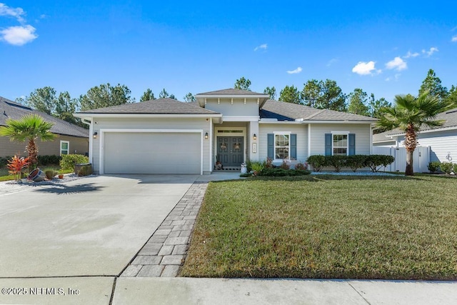 view of front of property with a garage and a front lawn