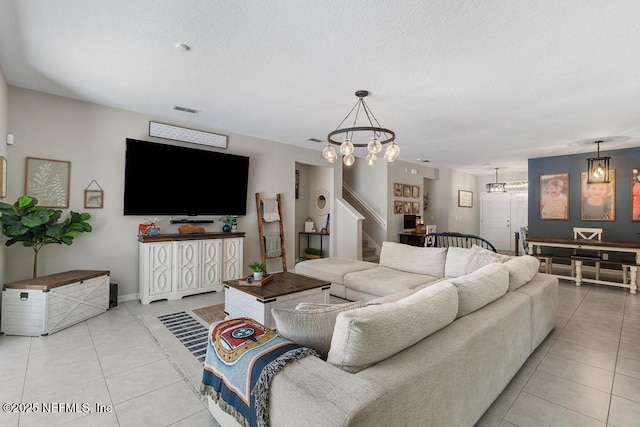 tiled living room featuring a notable chandelier