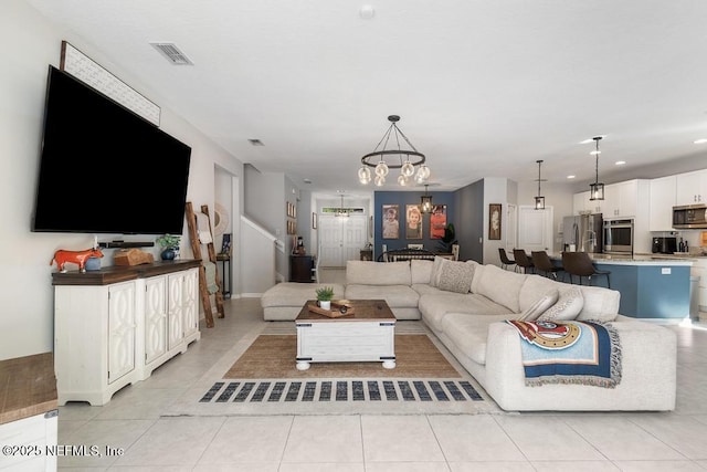 tiled living room featuring a notable chandelier