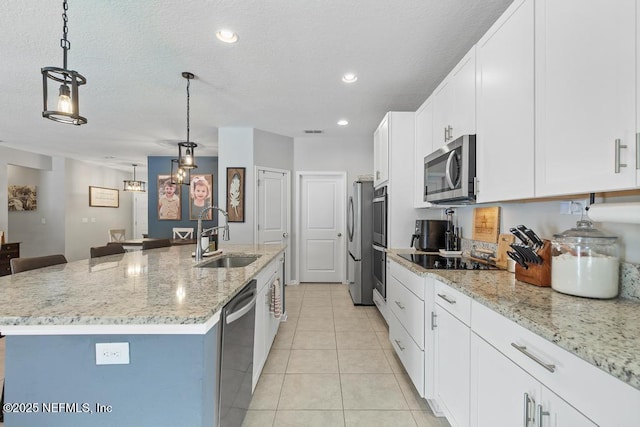 kitchen with sink, an island with sink, hanging light fixtures, and appliances with stainless steel finishes