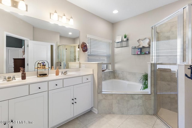 bathroom featuring separate shower and tub, tile patterned flooring, and vanity