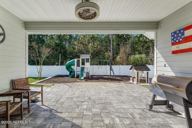 view of patio / terrace featuring a playground and area for grilling