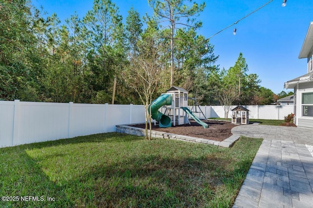 view of yard featuring a playground and a patio area