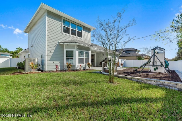 back of house featuring a patio, a playground, and a lawn