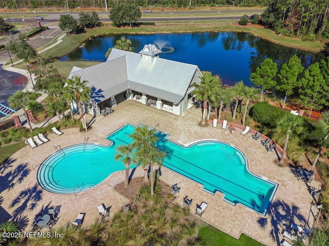 view of swimming pool with a patio and a water view