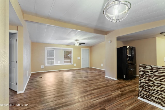 unfurnished living room featuring ceiling fan, beam ceiling, and dark hardwood / wood-style floors