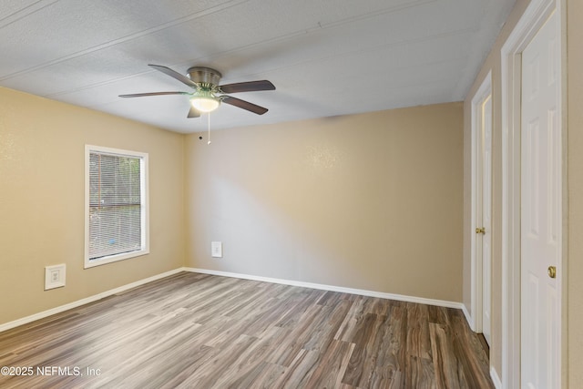 spare room with ceiling fan, a textured ceiling, and wood-type flooring