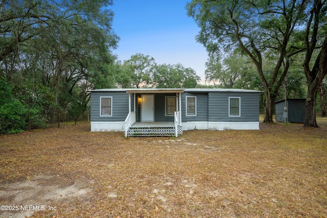 manufactured / mobile home with covered porch and a storage unit