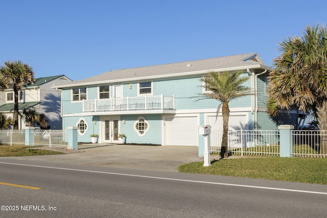 view of front of home with a balcony and a garage